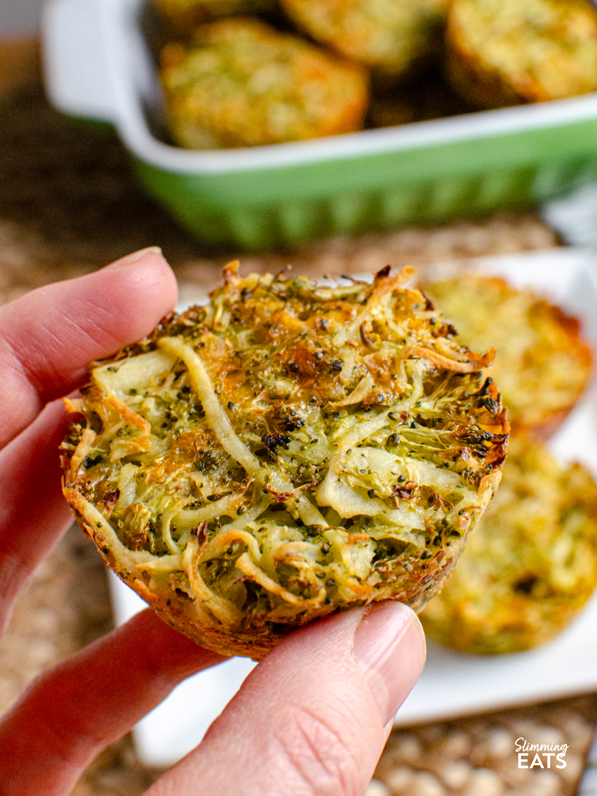 one cooked broccoli potato cheddar hash brown being picked up with hand