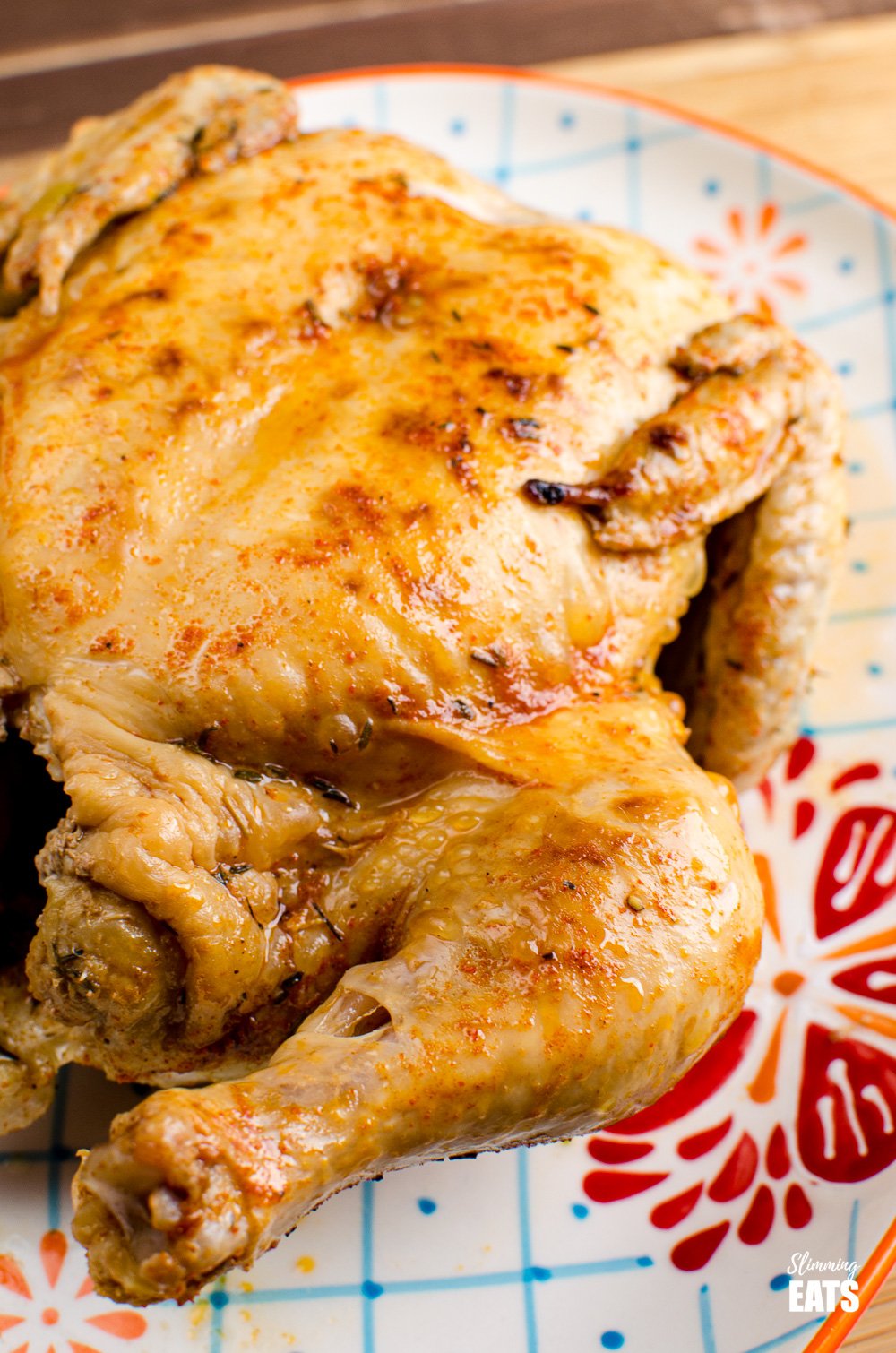 pressure cooked whole chicken on a patterned oval plate