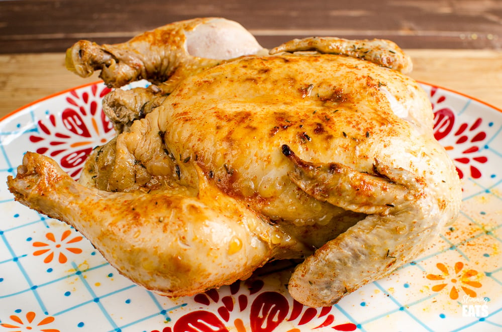 cooked whole chicken from instant pot on oval patterned plate