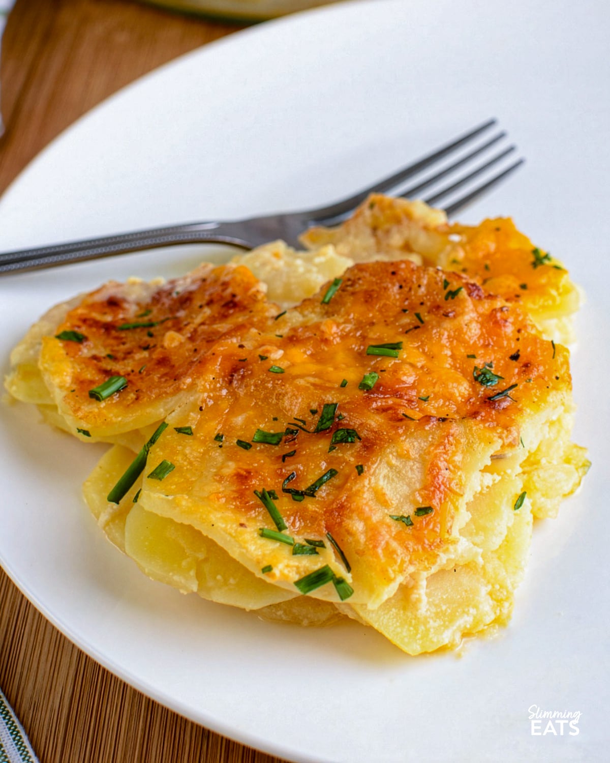 slice of scalloped potatoes on a white plate