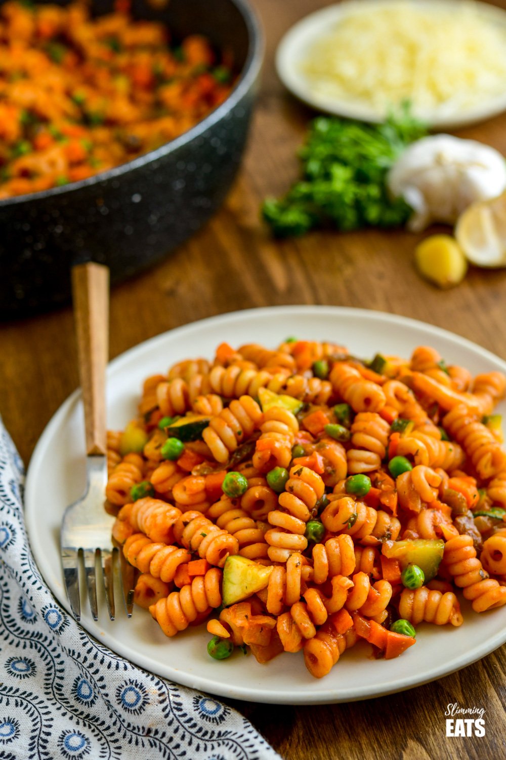 Delicious One Pot Speed Pasta - a perfect quick meal for the whole family to dig in enjoy. Dairy free, vegetarian, Slimming Eats and Weight Watchers friendly serving of one pot speed pasta on white plate with fork