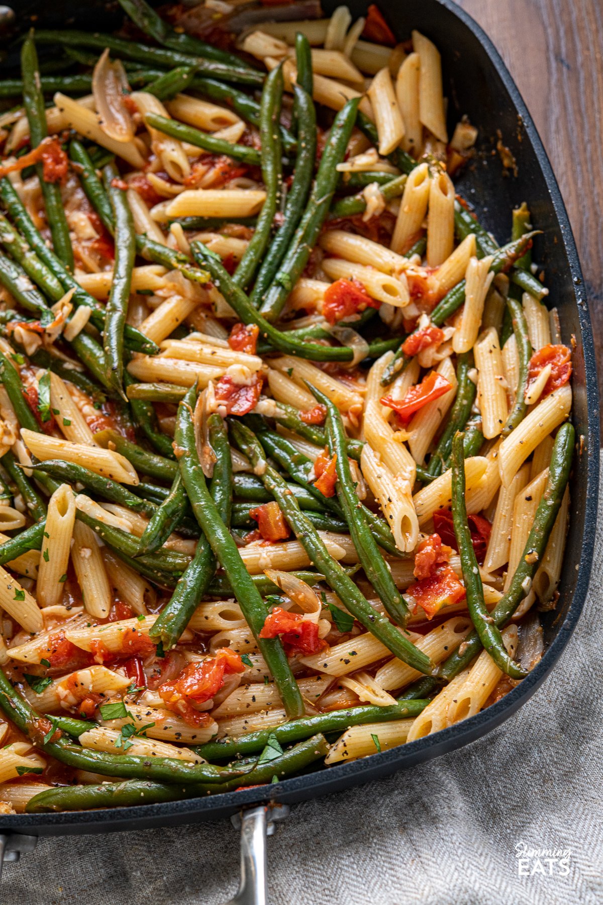 close up of Roasted Green Bean and Tomato Pasta in all clad square skillet