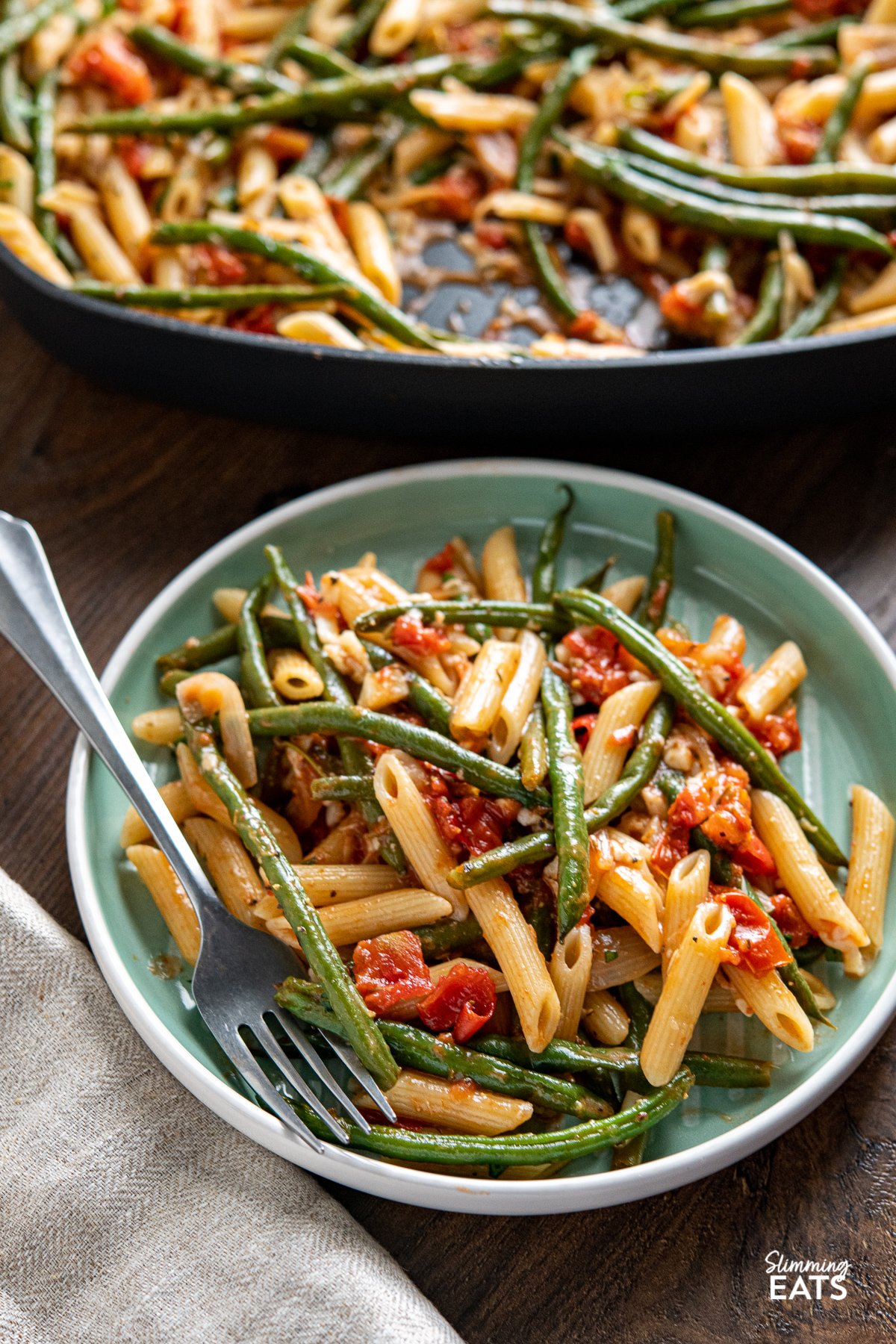 serving of Roasted Green Bean and Tomato Pasta on turquoise plate