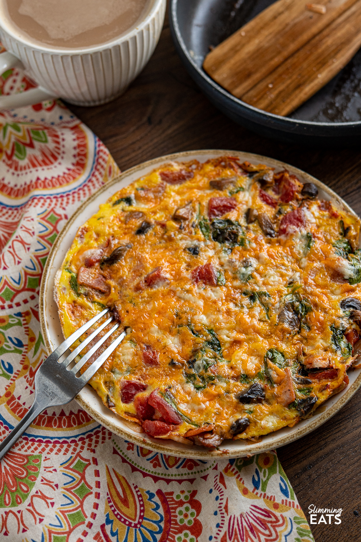 Speedy Breakfast Frittata on plate with fork, pan and coffee in background