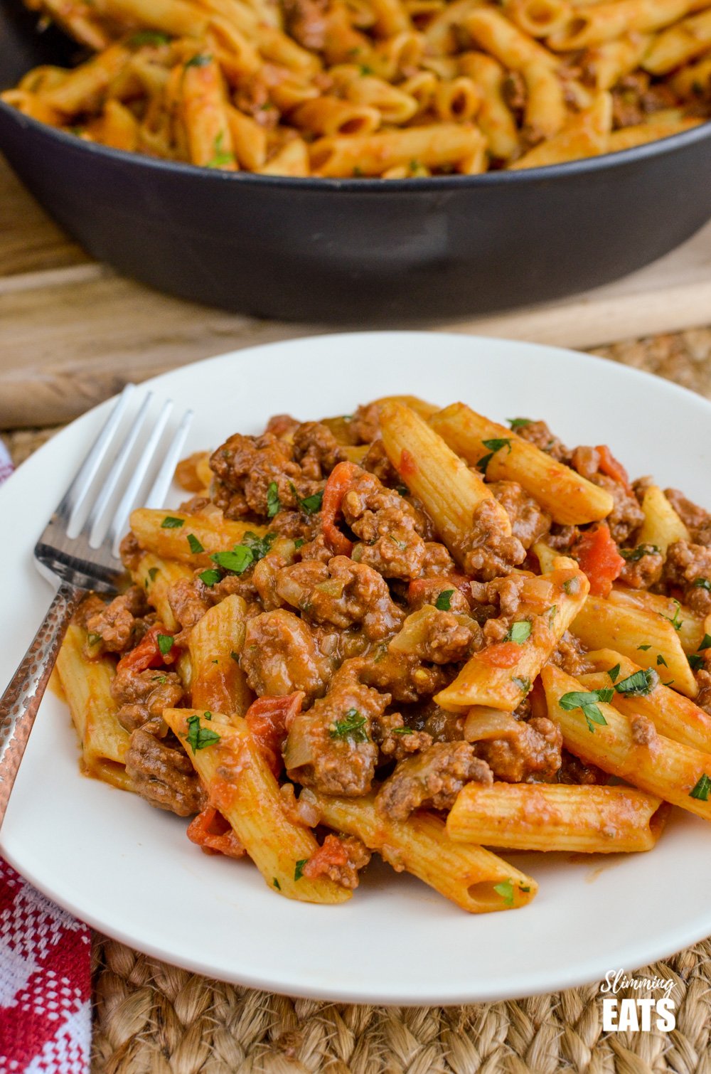 one pot cheeseburger pasta on white plate with fork