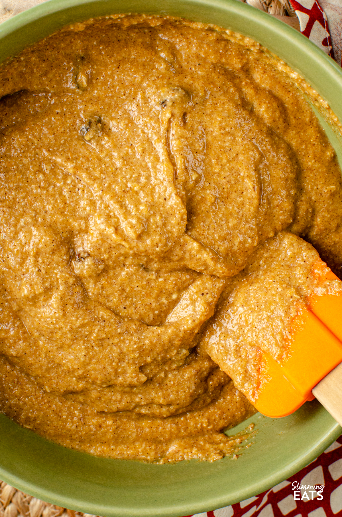 Pumpkin Sultana Muffins batter in a bowl with spatula