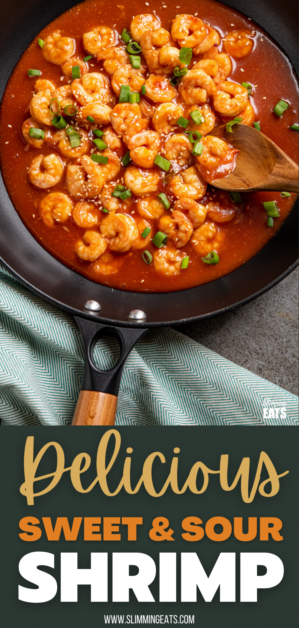 close up sweet and sour shrimp in black frying pan with wooden spoon
