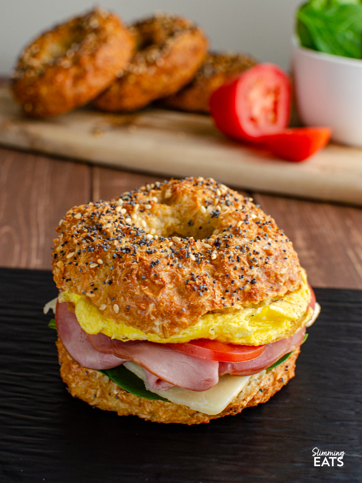 oat bagel filled with egg, cheddar, tomato and baby spinach
