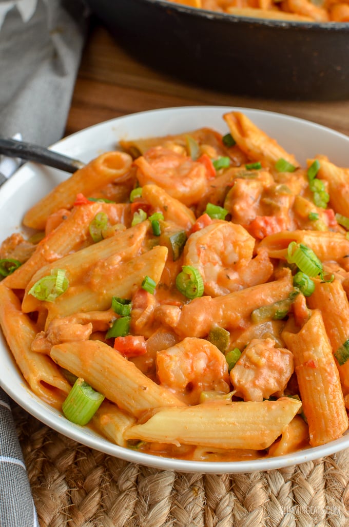 Dig into a bowl of this delicious spicy One Pot New Orleans Cajun Pasta - the only regret will be not having enough for seconds. Slimming Eats and Weight Watchers friendly white bowl with One Pot New Orleans Cajun Pasta, chicken, pasta and shrimp visible