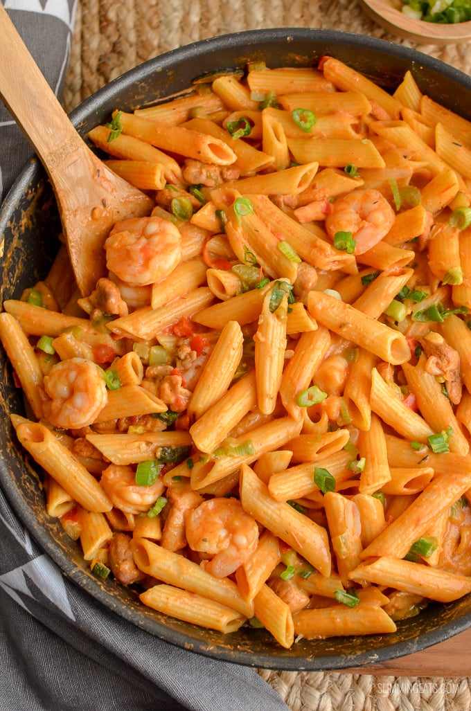 Dig into a bowl of this delicious spicy One Pot New Orleans Cajun Pasta - the only regret will be not having enough for seconds. Slimming Eats and Weight Watchers friendly New Orleans Cajun Pasta in a deep black frying pan with wooden spoon