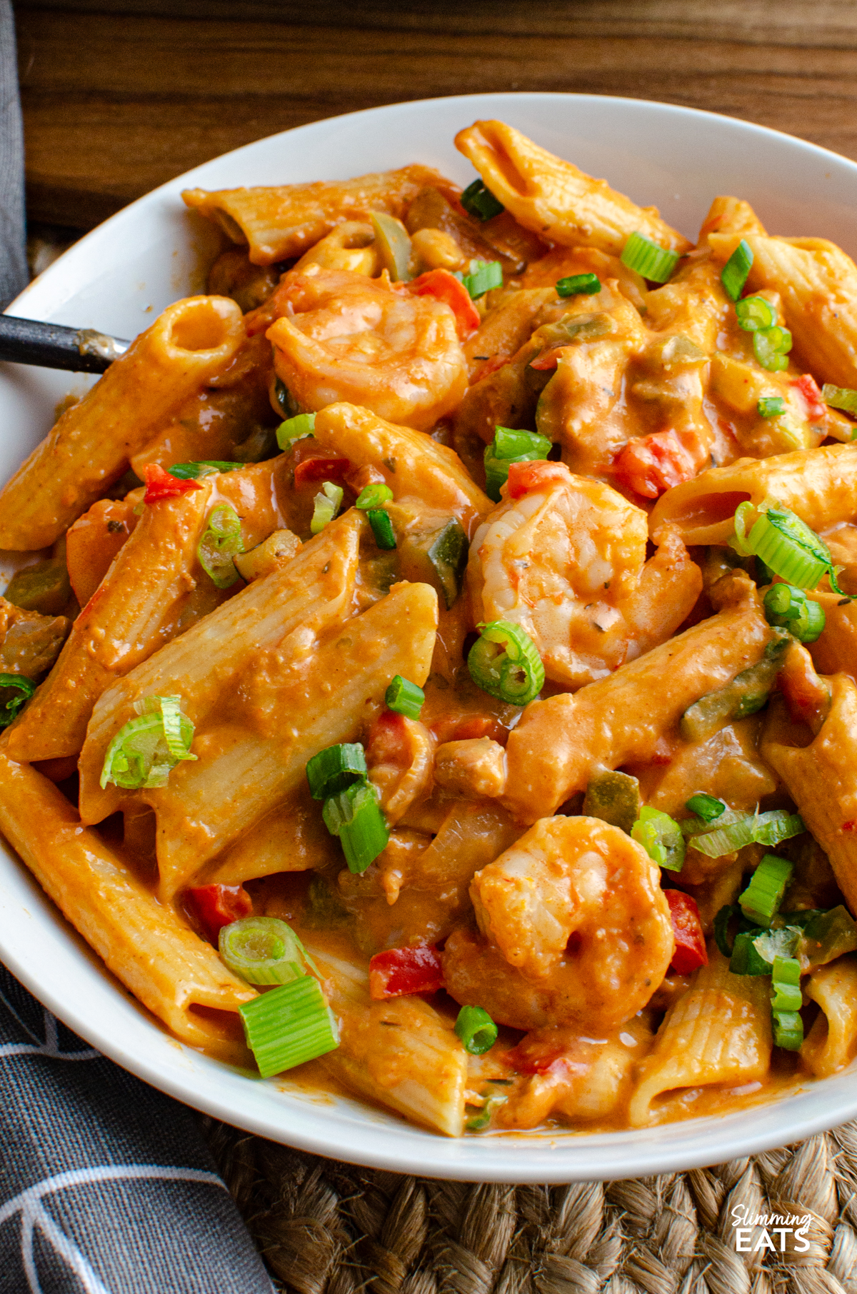 white bowl with One Pot New Orleans Cajun Pasta, chicken, pasta and shrimp visible