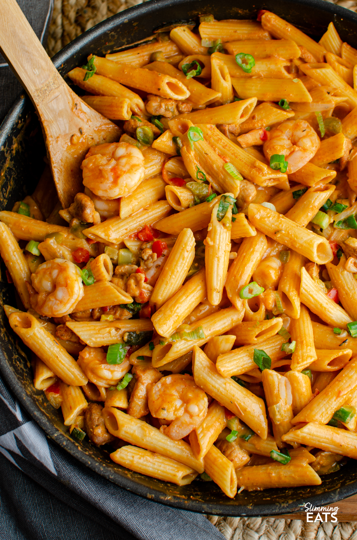 New Orleans Cajun Pasta in a deep black frying pan with wooden spoon