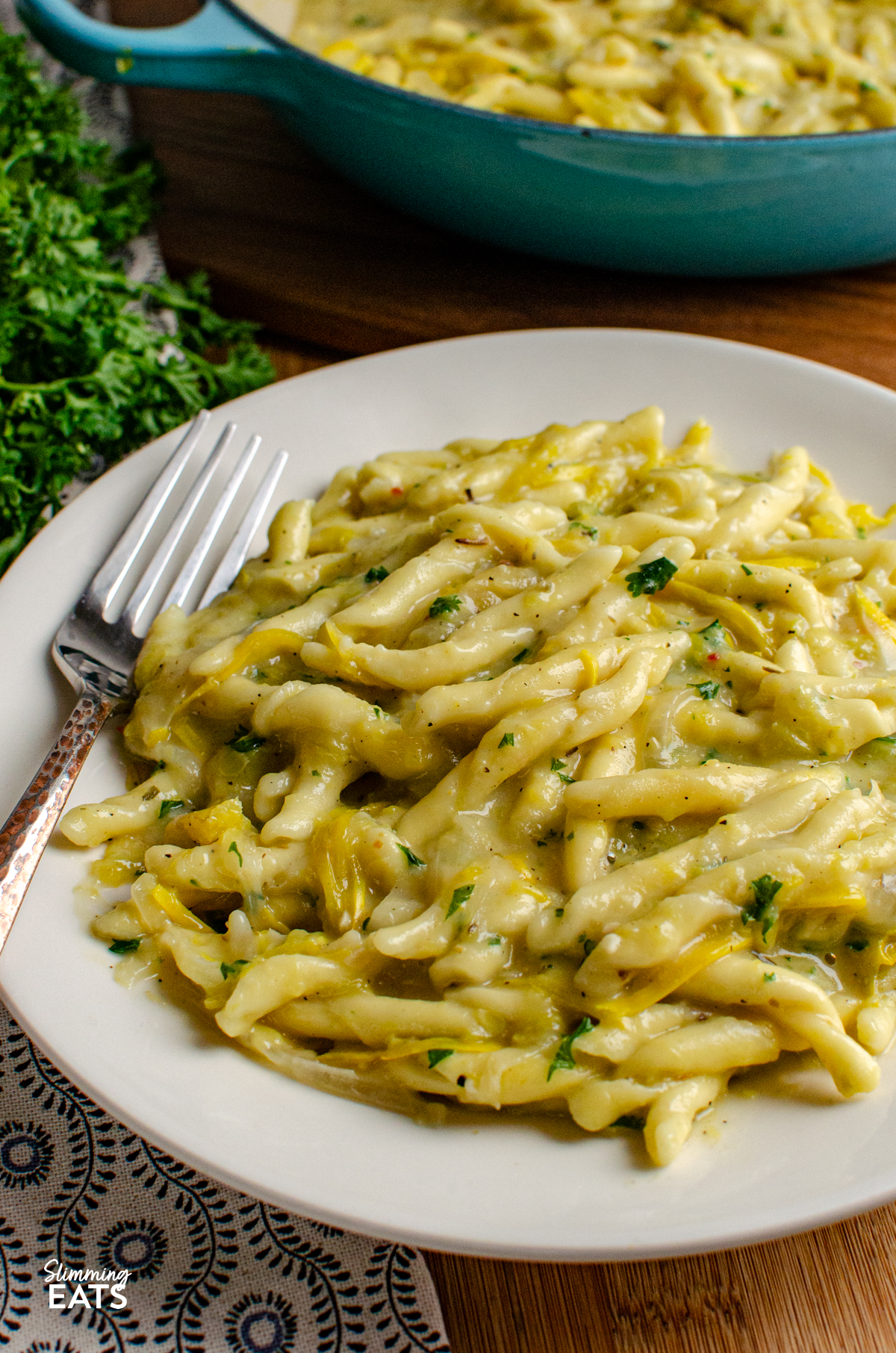 Dairy Free Yellow Zucchini Pasta - a creamy comforting one pot pasta dish made with simple ingredients and completely dairy free. Sweet yellow zucchini, garlic and pasta come together in a silky sauce, with light coconut milk adding that delicious creamy texture without needing any cheese or cream. serving of One Pot Dairy Free Creamy Yellow Zucchini Pasta on a white plate with a fork
