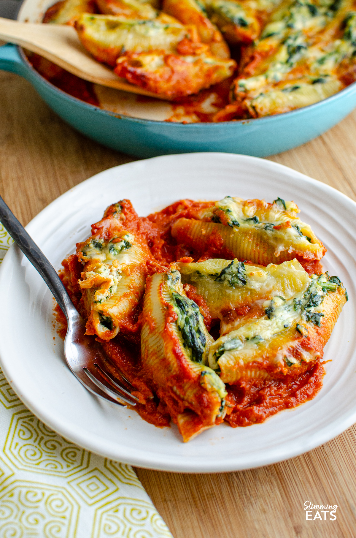 Ricotta and Spinach Stuffed Pasta Shells served on a white plate, accompanied by a fork