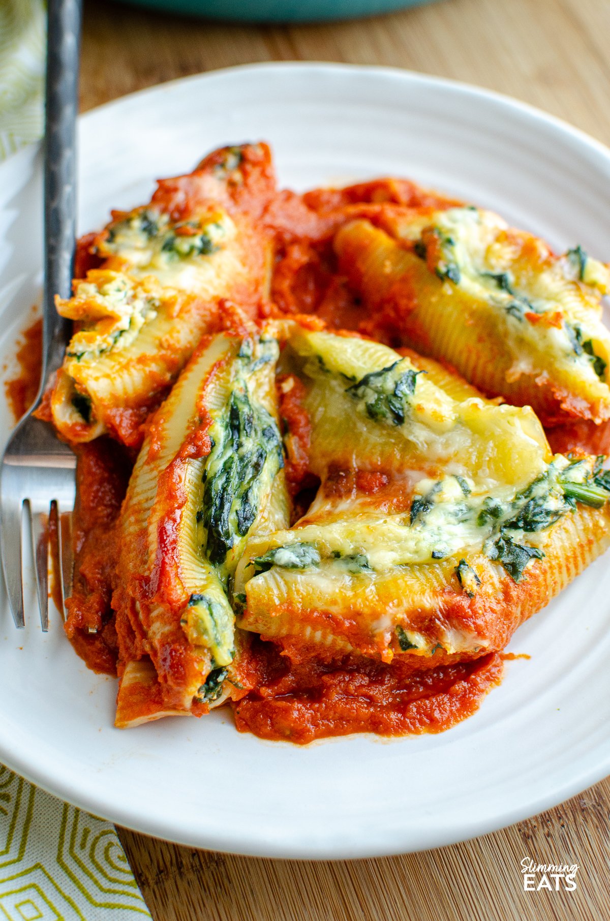 Ricotta and Spinach Stuffed Pasta Shells served on a white plate, accompanied by a fork