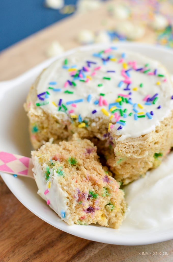 Funfetti Birthday Cake Mug Cake - a delicious vanilla flavour cake scattered with rainbow sprinkles and topped with white chocolate all cooked in a mug in the microwave in just a few minutes. Slimming World and Weight Watchers friendly | www.slimmingeats.com