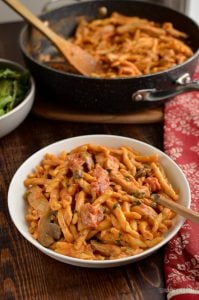 creamy one pot pork pasta in a bowl with fork
