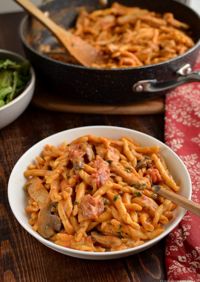creamy one pot pork pasta in a bowl with fork