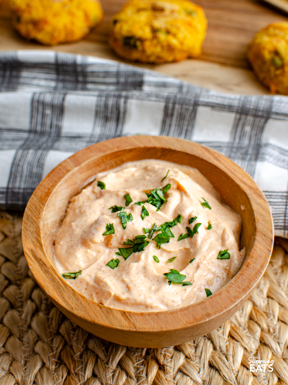 louisiana remoulade dip in a wooden bowl with tuna couscous patties