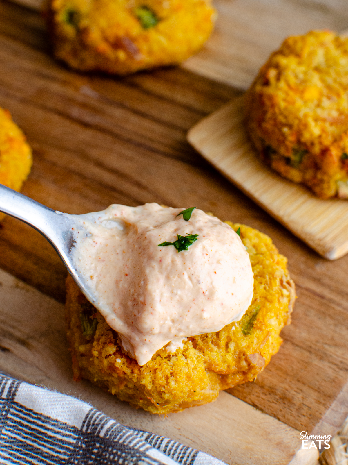 louisiana remoulade being spooned onto cheddar tuna couscous patties