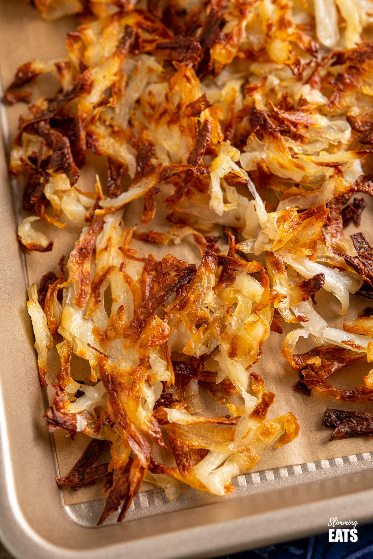 close up of shredded potato hash browns on baking tray