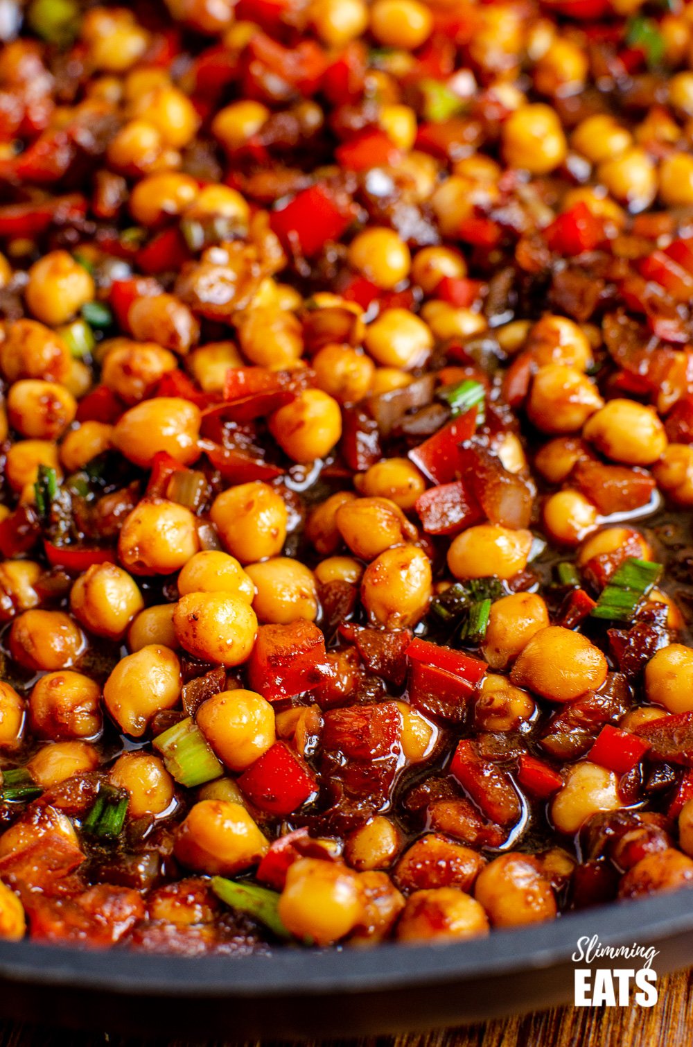 Chinese 5 spice Chickpeas - the perfect quick and easy recipe for anyone looking for a meat-free Chinese Fakeaway meal. Gluten free, dairy free, vegan, Slimming Eats and Weight Watcher friendly close up of Chinese 5 spice Chickpeas in black frying pan