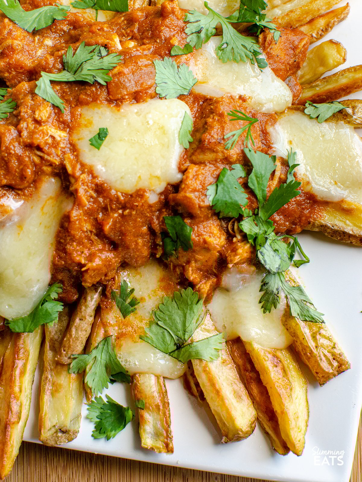 Butter Chicken Poutine!! - The ultimate dish for leftover butter chicken - crispy golden fries, topped with butter chicken and melted cheese make this one of those recipes you will not ever want to end. Gluten Free