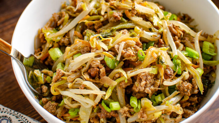 spring roll in a bowl portion dished up in a white bowl with a spoon