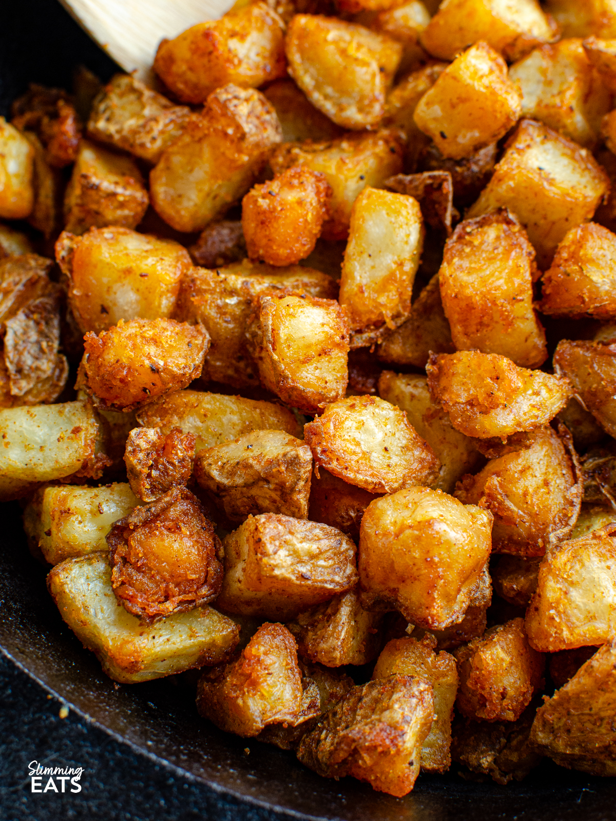 cooked home fries in a cast iron skillet