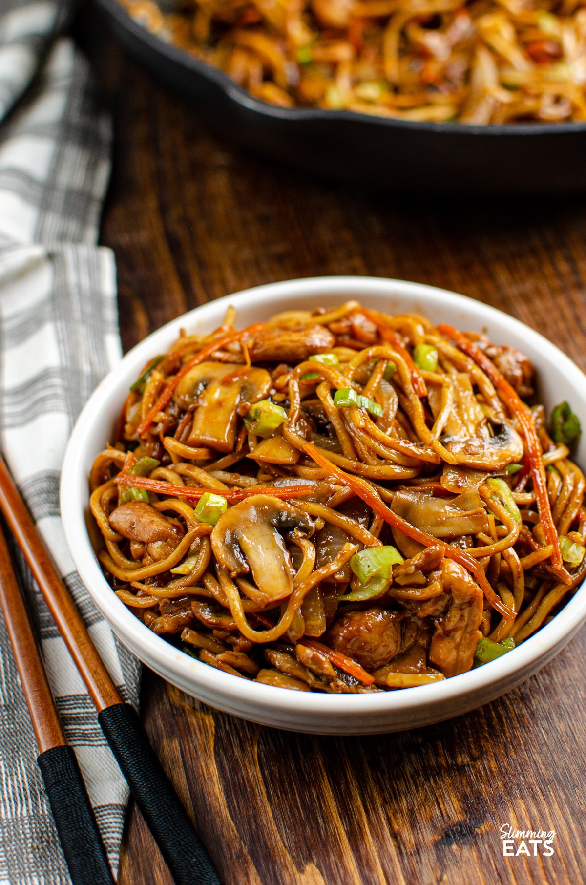 Ginger Chicken with Mushrooms and Noodles in white bowl with chopsticks on side