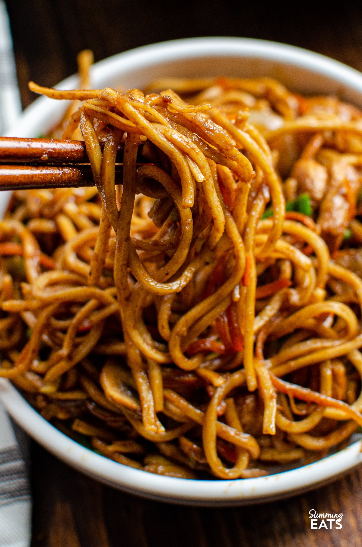 Ginger Chicken with Mushrooms and Noodles being pulled from bowl with chopsticks