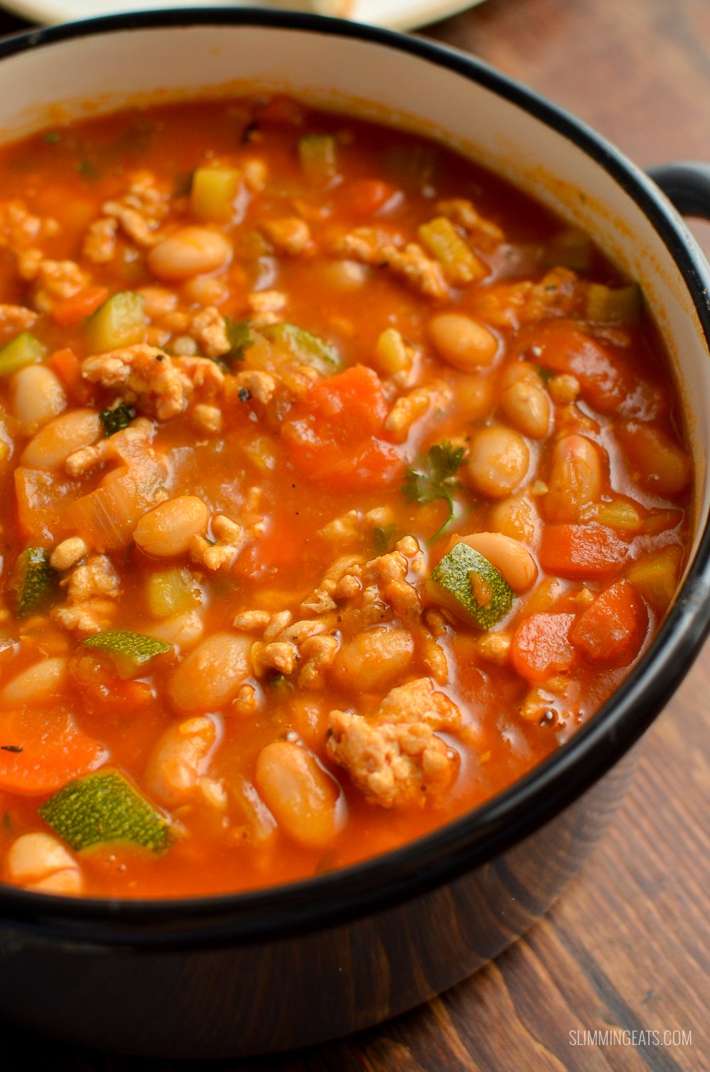 close up of ground turkey vegetable bean soup in grey saucepan