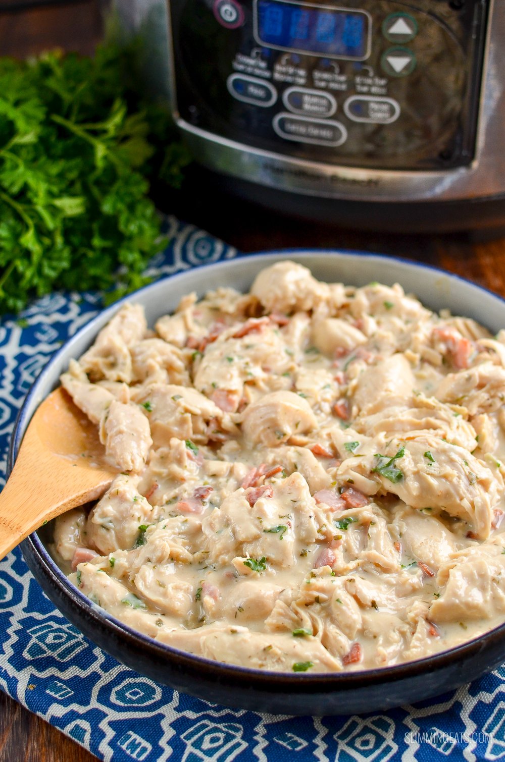 Healthier Slow Cooker Crack Chicken - the ultimate family-friendly creamy chicken recipe topped with the yummy smokey flavour of bacon. Oh my!! #slimming #weightwatchers #chicken #slowcooker #glutenfree #bacon #creamy slow cooker crack chicken in dish with slow cooker in background