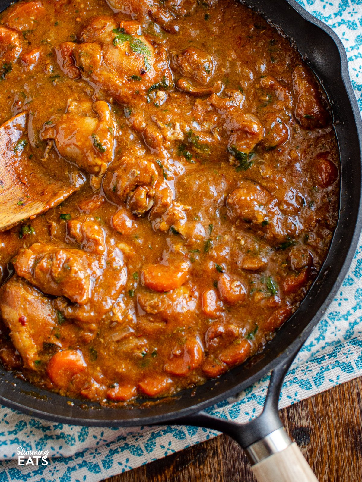 Homemade Sweet and Spicy Ginger Chicken - a delicious bursting with flavour, easy and simple meal for the entire family. close up of Homemade Sweet and Spicy Ginger Chicken in a black frying pan with wooden handle
