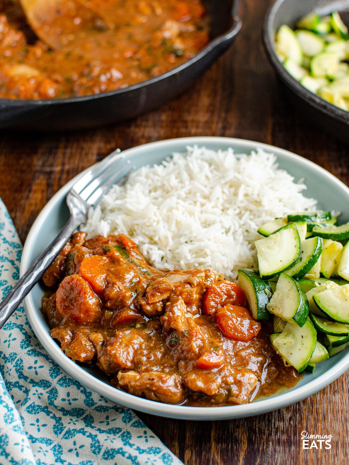 Homemade Sweet and Spicy Ginger Chicken on blue grey plate with rice and courgette