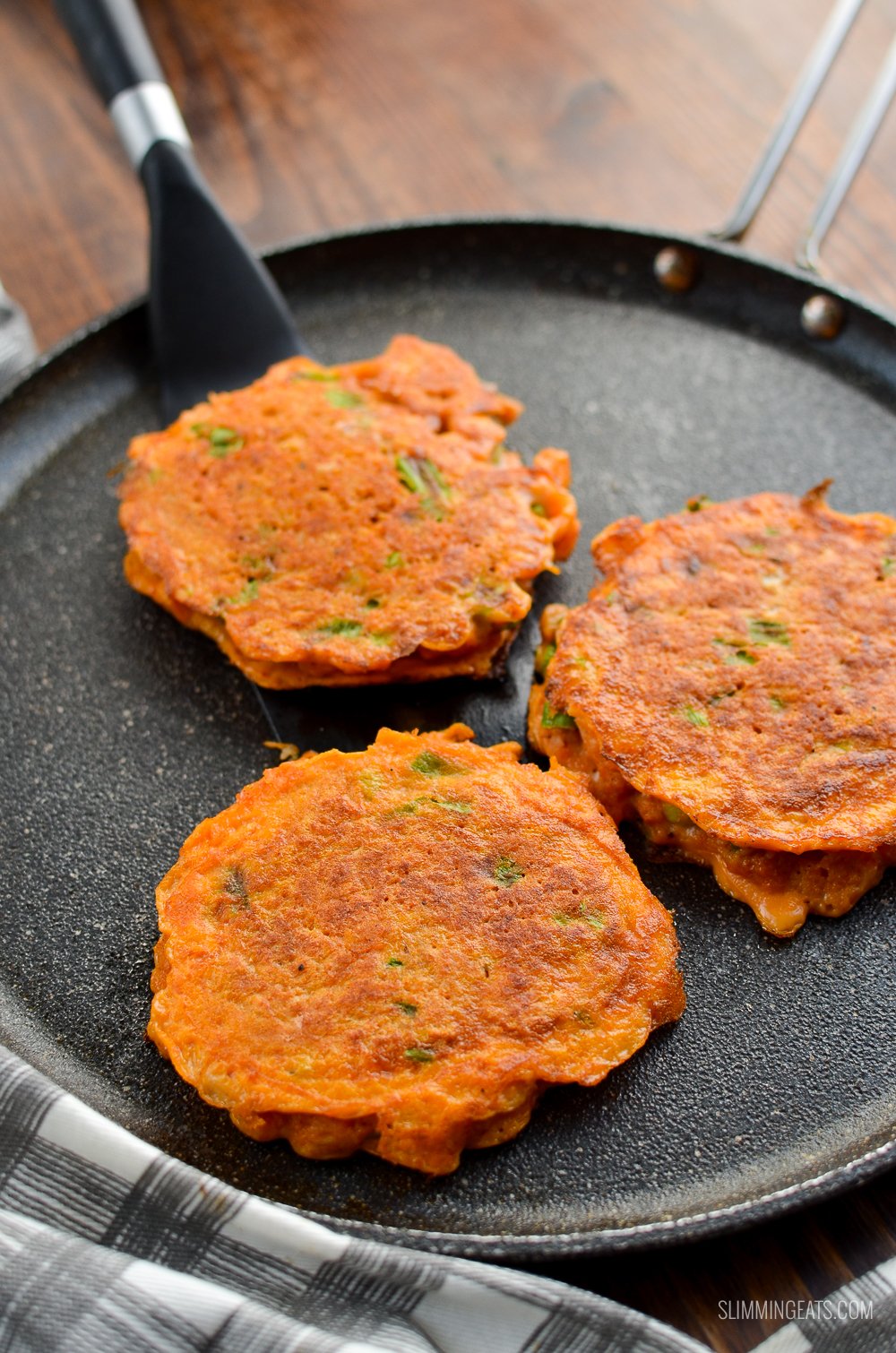 Seriously addictive Thai Crab Cakes for a perfect light meal or appetizer. #slimmingeats #weightwatchers #Thai #crab #glutenfree #dairyfree #paleo" 3 thai crab cakes on a skillet