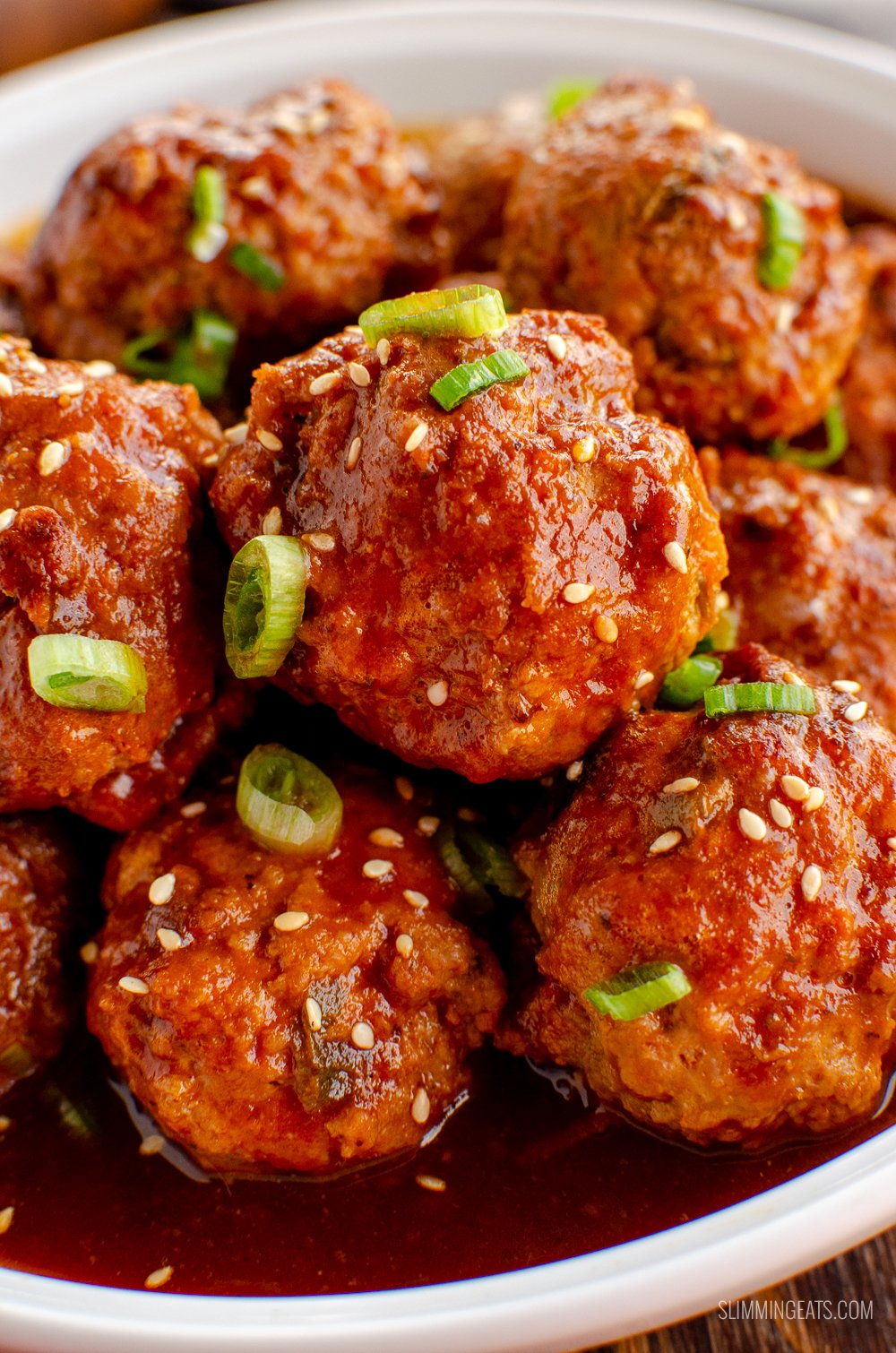 close up of firecracker chicken meatballs in white bowl