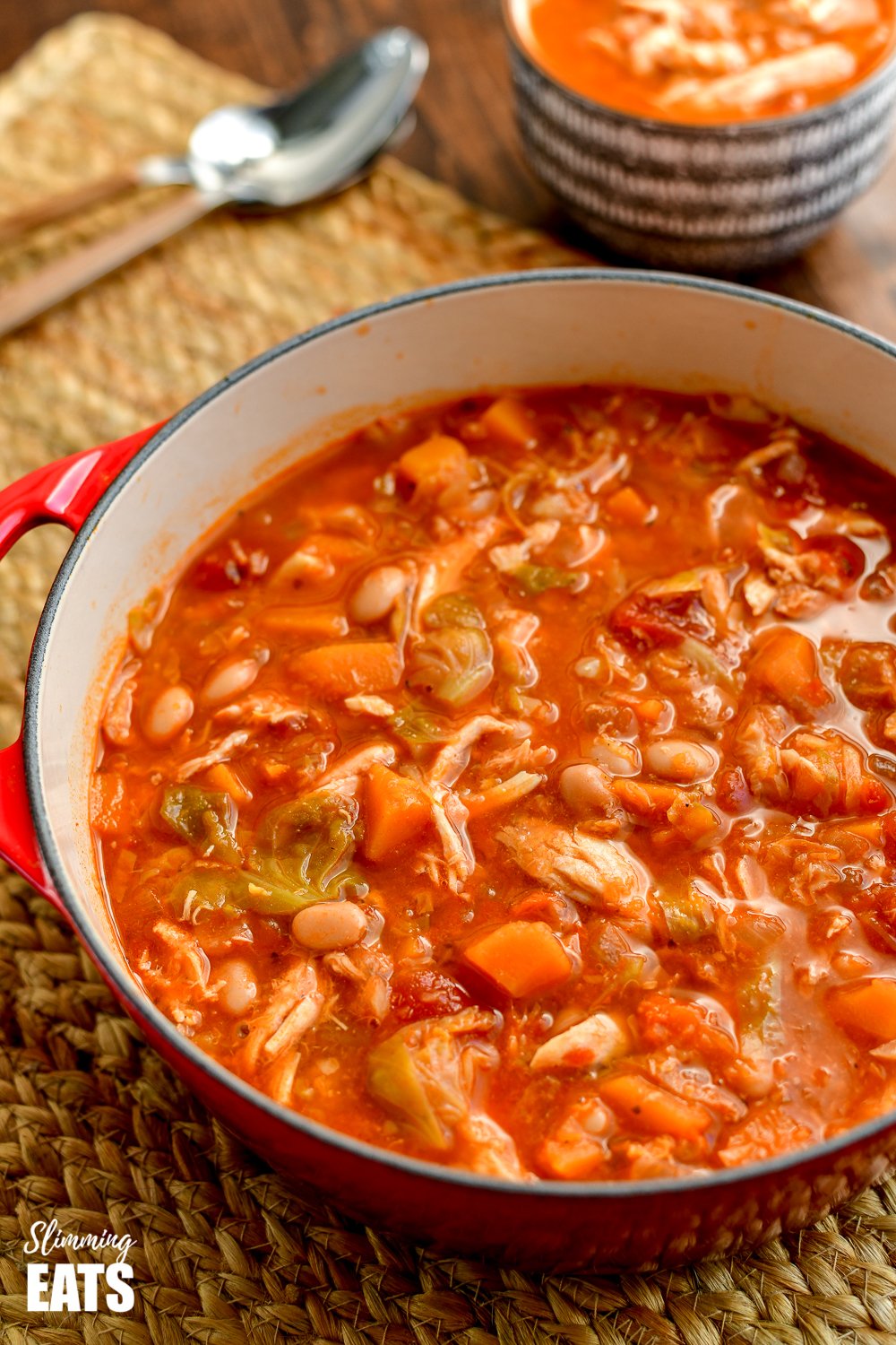 leftover chicken brussels sprouts and bean soup in red dutch oven pot