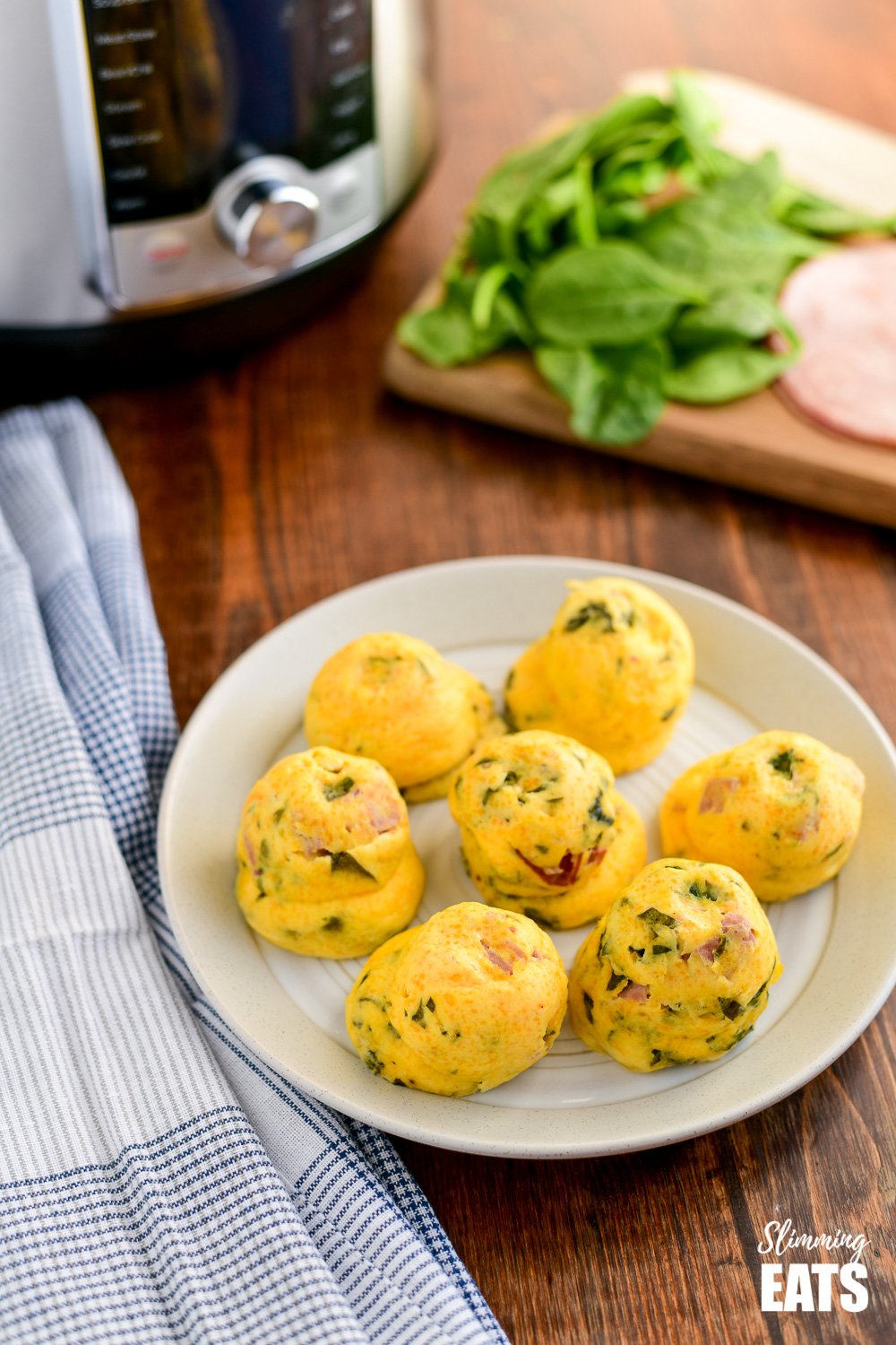 Instant Pot Sous Vide Egg Bites on a cream plate with instant pot and chopping board with ingredients in background