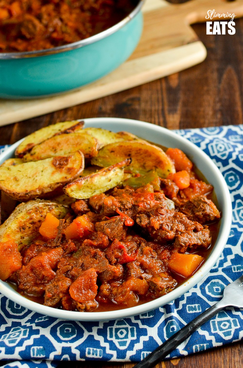 Paprika Beef - tender chunks of beef in a rich smokey paprika tomato sauce with chunks of butternut squash. #glutenfree #dairyfree #instantpot #slowcooker #slimmingeats #weightwatchers #beef paprika beef on a plate with potato wedges