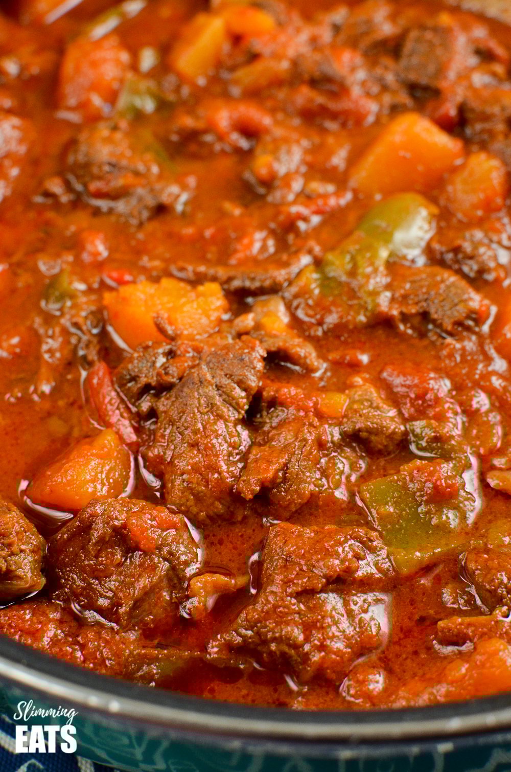 Paprika Beef - tender chunks of beef in a rich smokey paprika tomato sauce with chunks of butternut squash. #glutenfree #dairyfree #instantpot #slowcooker #slimmingeats #weightwatchers #beef close up of paprika beef in pan
