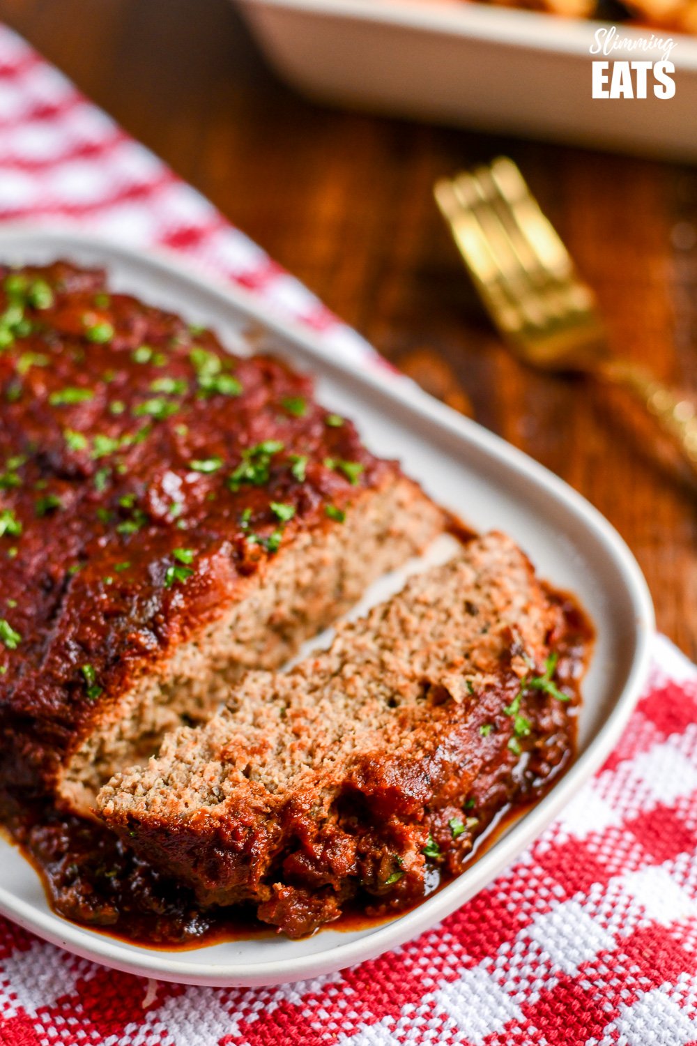 close up of sliced slow cooker chicken mushroom meatloaf on white plate