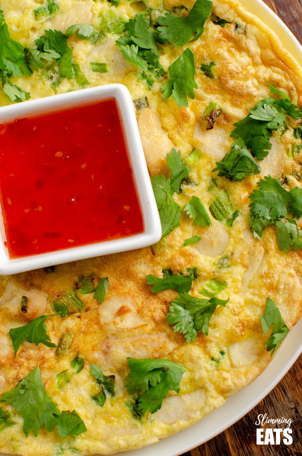 close up of Thai Chicken Omelete with sweet chilli sauce and coriander