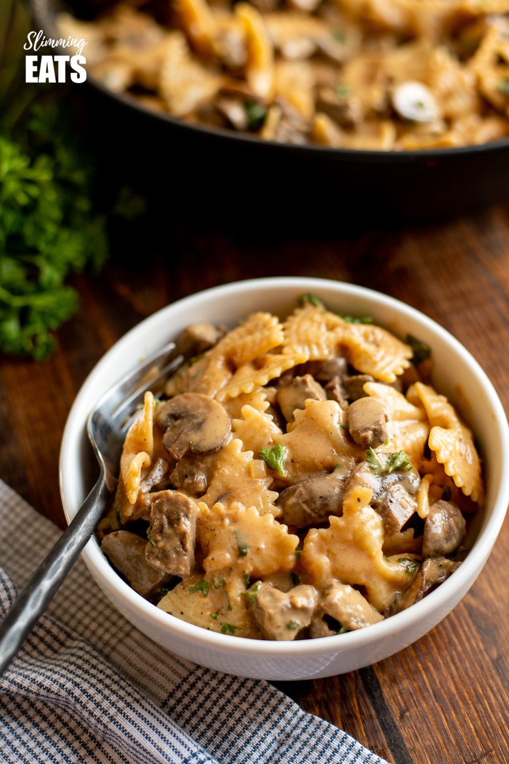 one pot beef stroganoff pasta serving in white bowl with fork