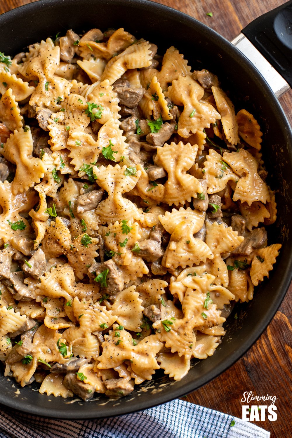 over top view of one pot beef stroganoff pasta in black frying pan