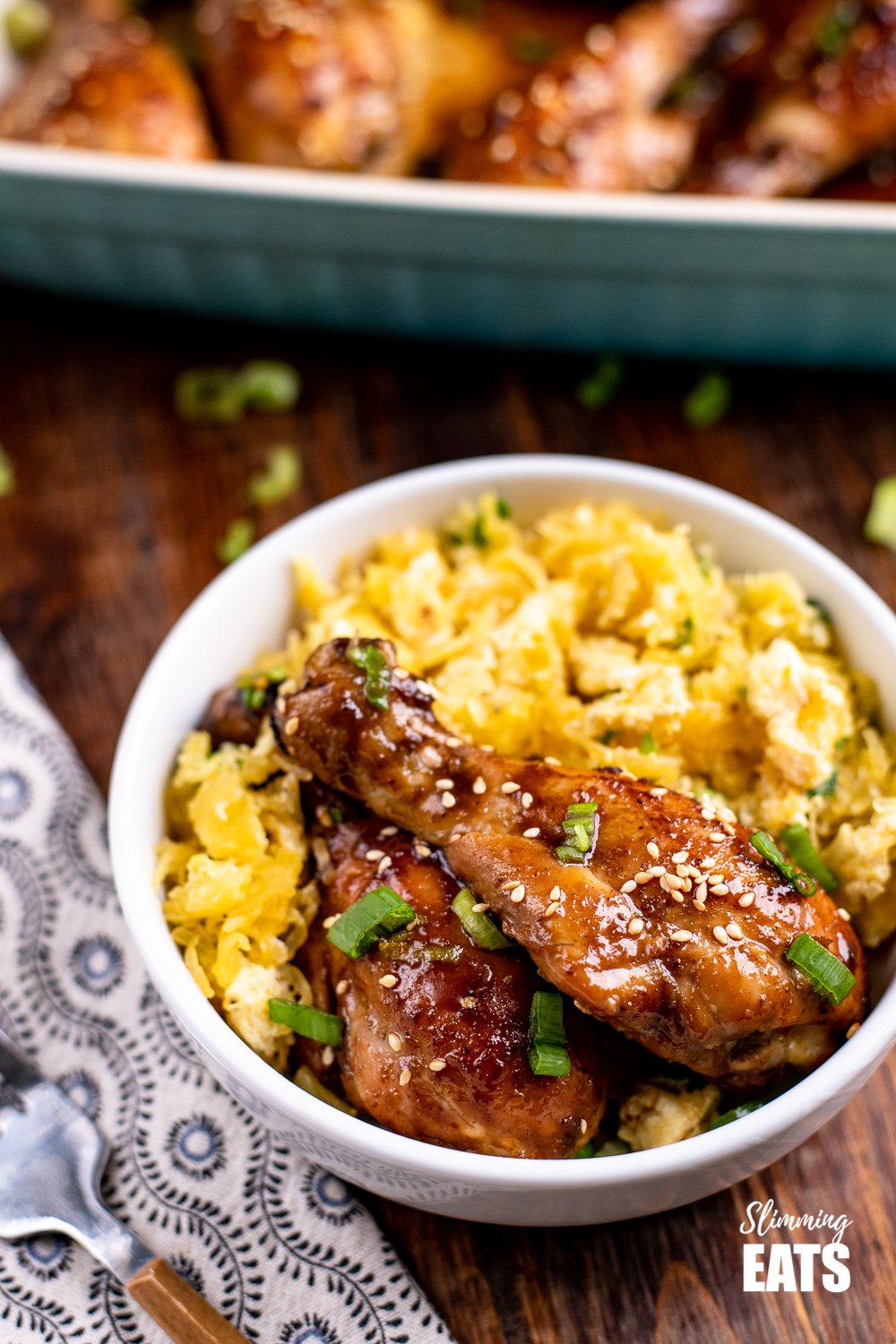 chinese five spice chicken drumstick in white bowl with egg fried spaghetti squash