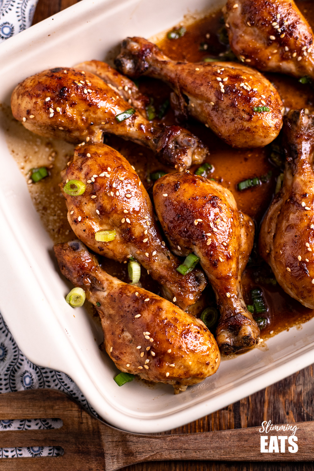 close up of Chinese five spice chicken drumsticks in oven proof dish