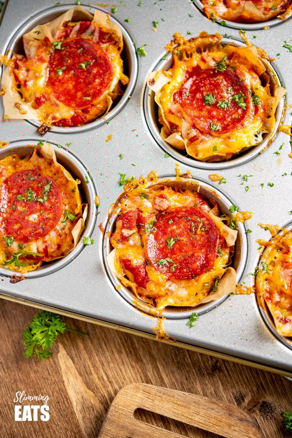 Drool-worthy Pepperoni Pizza Egg Bites - the mini cheesy bites are perfect for parties, tasters, lunches. Slimming and Weight Watchers friendly close up of Pepperoni Pizza Egg Bites in a muffin tray