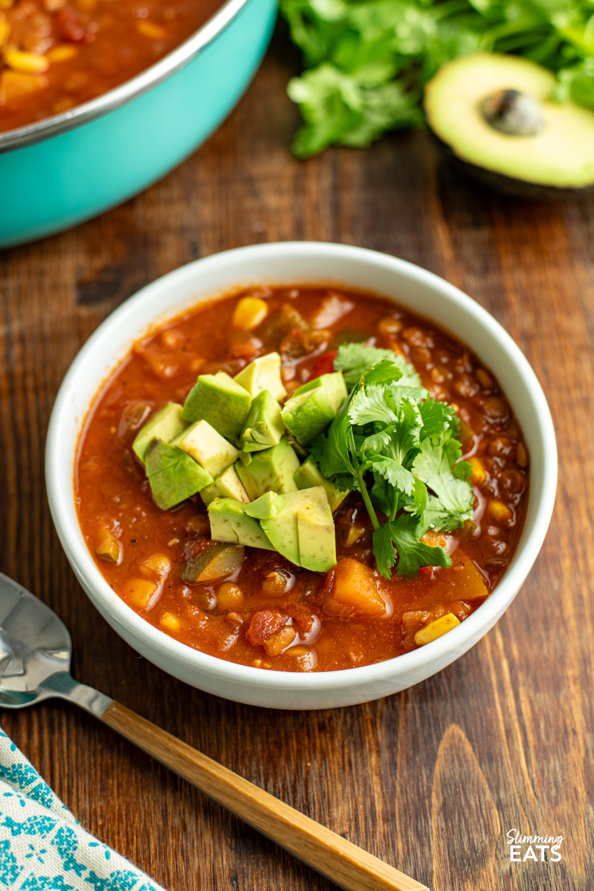 Taco Lentil Soup - the delicious spicy flavour of tacos using lentils instead of meat for a filling hearty meal that even the kids will enjoy. Gluten Free, Dairy Free, Vegan, Slimming and Weight Watchers friendly taco lentil soup in white bowl topped with avocado and cilantro