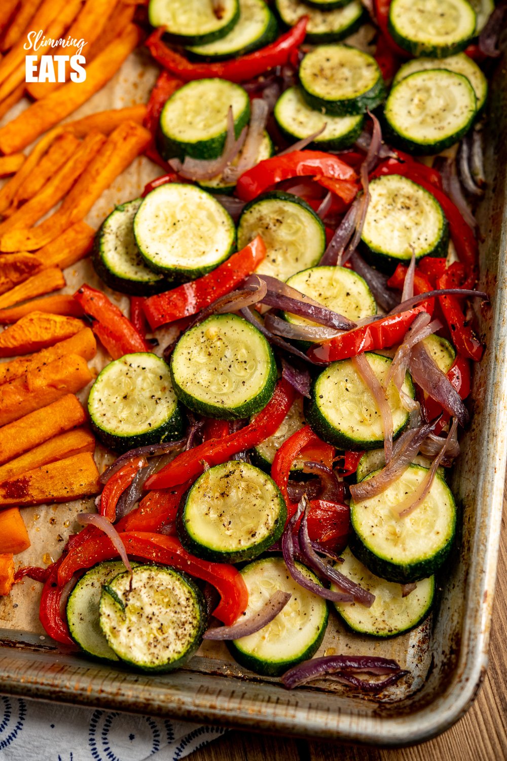 Yummy Beef Kofta Tray Bake - authentic Kofta kebabs with sweet potato fries and delicious roasted vegetables all finished off with a garlic yoghurt sauce. Gluten Free, Slimming Eats and Weight Watchers friendly close up of roasted zucchini, peppers and onion from Beef Kofta Tray Bake